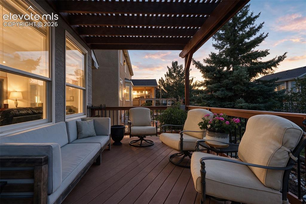 Image 2 of 50: Expansive outdoor deck featuring a rich wood-finish floor, overhead pergola