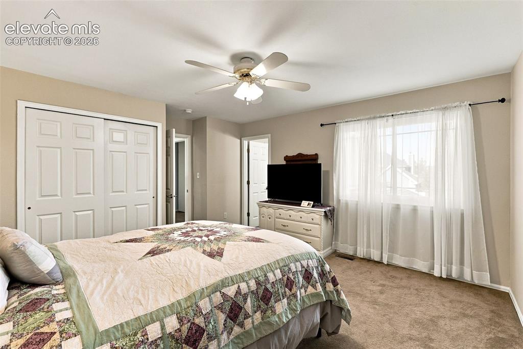 Image 26 of 50: Recessed lighting, ceiling fan, carpeted flooring, and a large window with