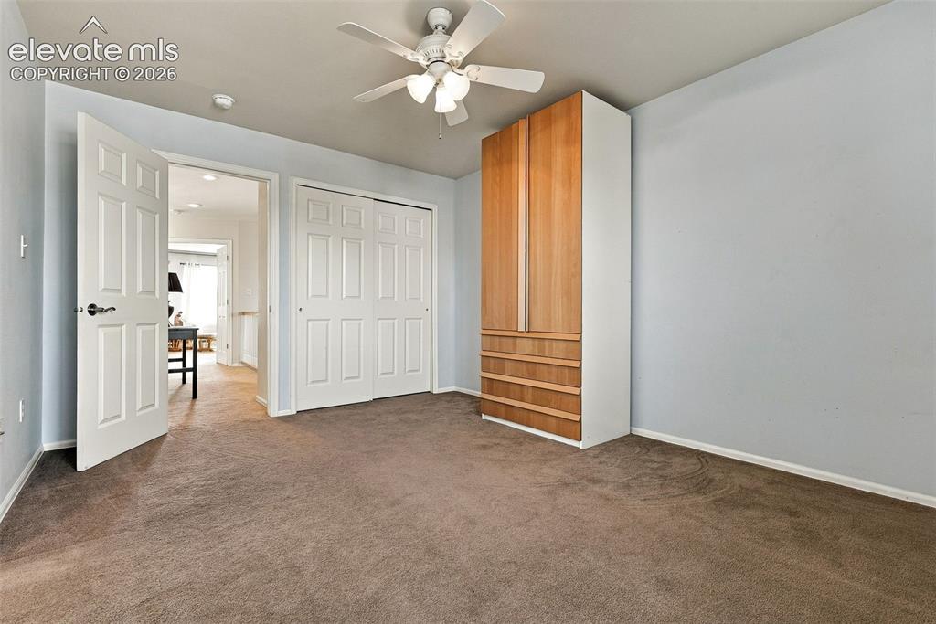 Image 30 of 50: Ceiling fan with light kit, built-in storage unit with wood-finish doors an