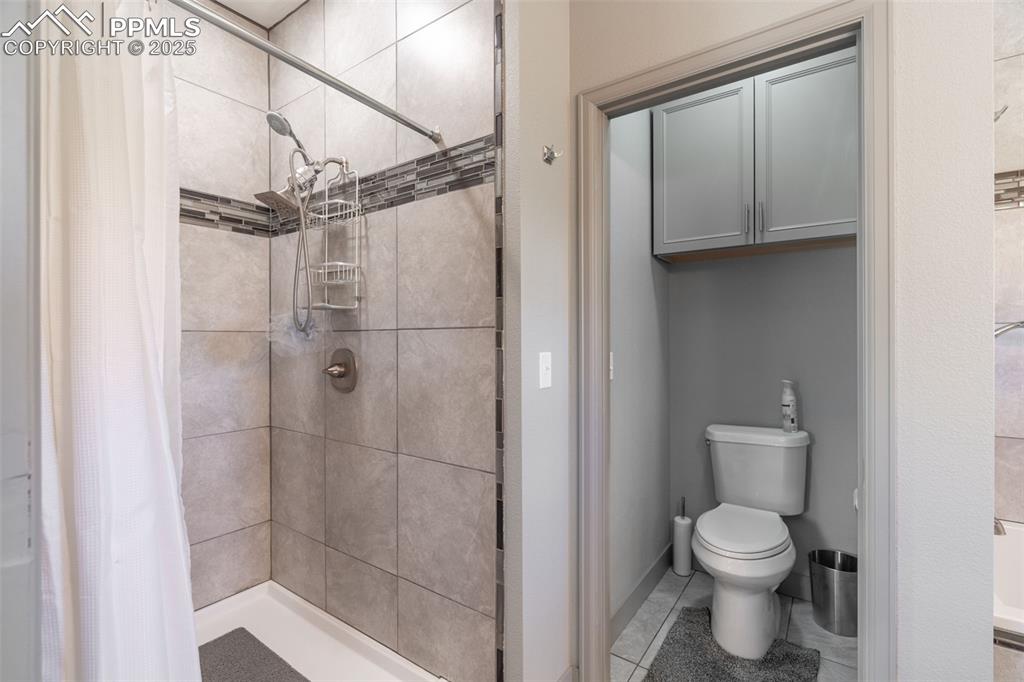 Image 14 of 41: Full bathroom with a stall shower
