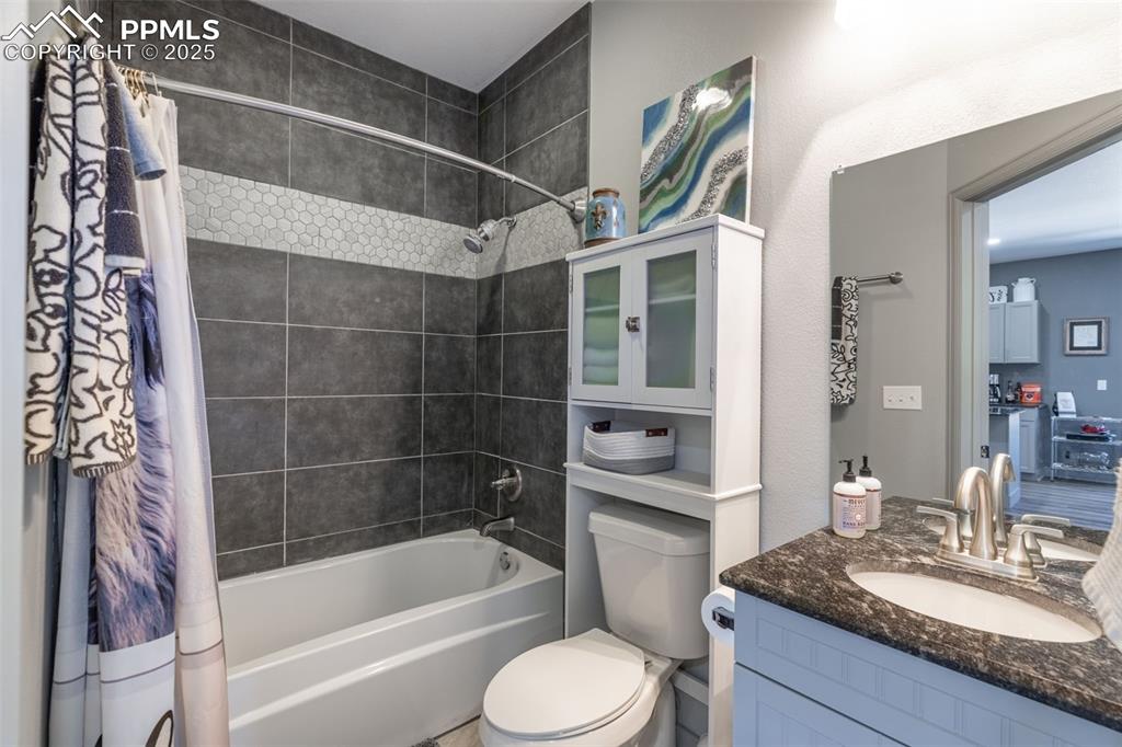 Image 22 of 41: Bathroom featuring shower / tub combo and vanity