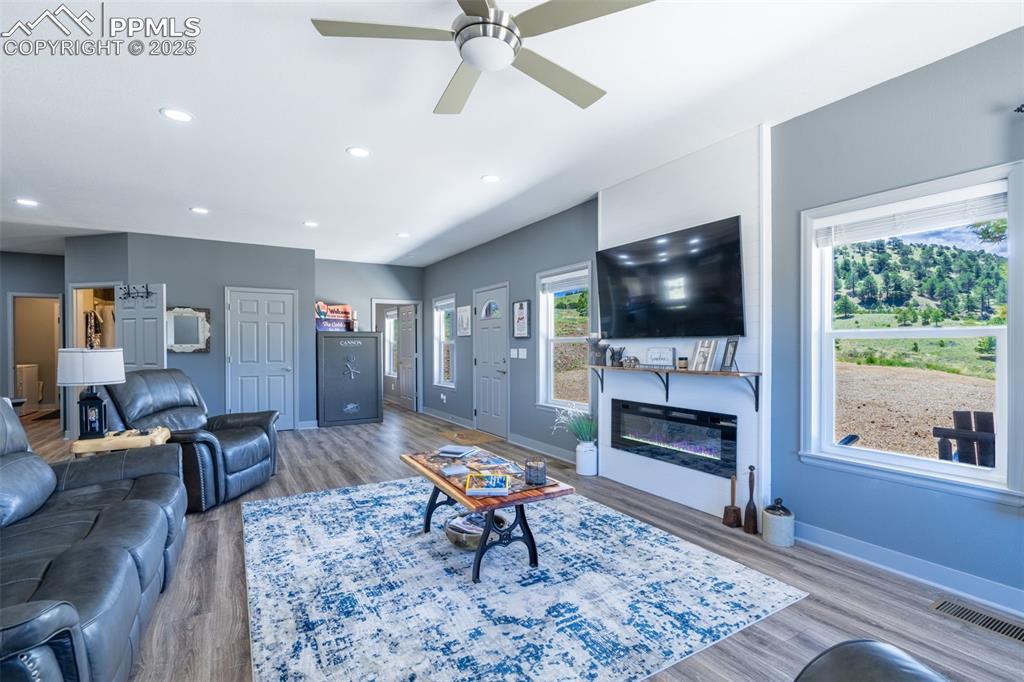 Image 3 of 41: Living room featuring wood finished floors, a ceiling fan, recessed lightin