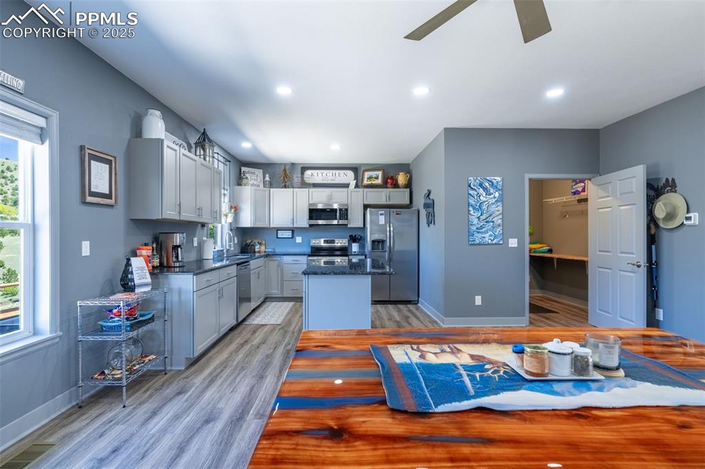 Image 7 of 41: Kitchen featuring stainless steel appliances, light wood-style flooring, ce
