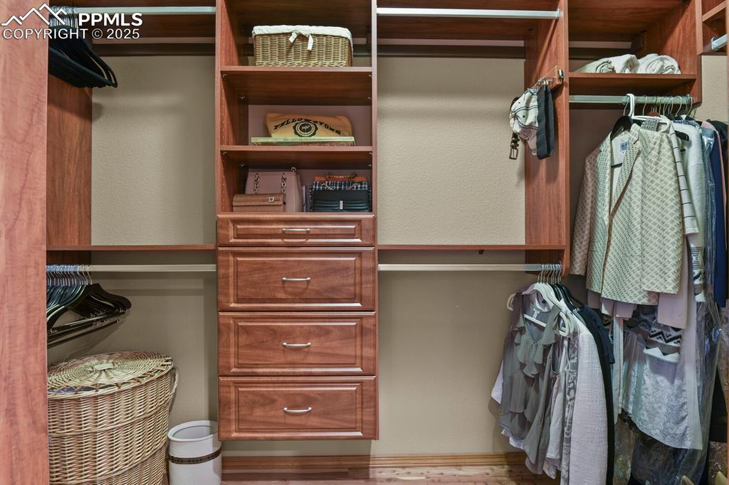 Image 20 of 49: Primary closet with uilt in closet drawers