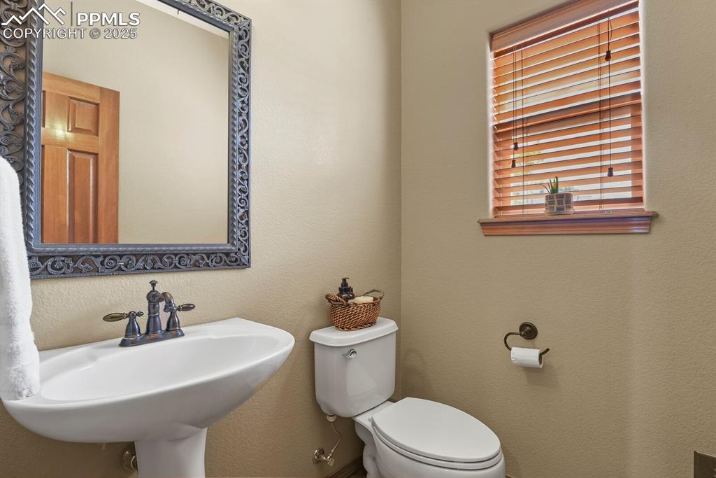 Image 22 of 49: 1/2 bath on main with hardwood flooring