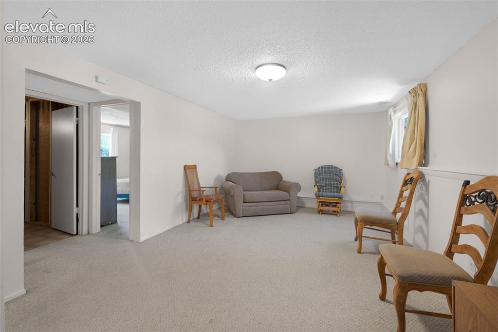 Image 13 of 25: Carpeted room with white painted walls and ceiling