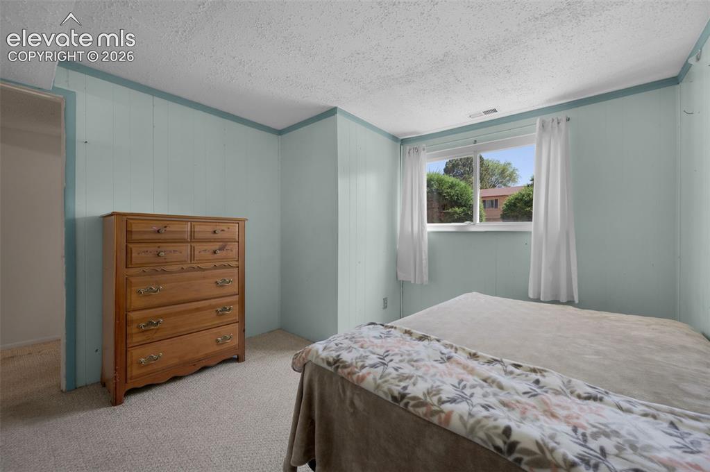 Image 15 of 25: Non-conforming lower level featuring light blue paneled walls and a window