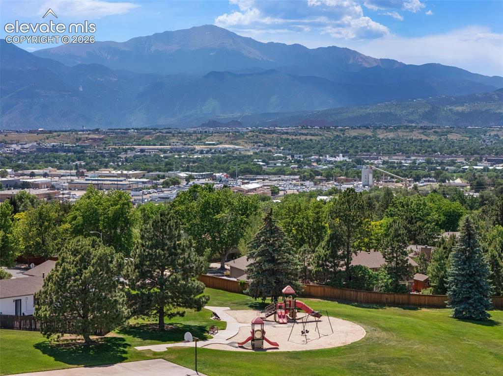 Image 21 of 25: Expansive grounds featuring a playground structure with swings and slides, 