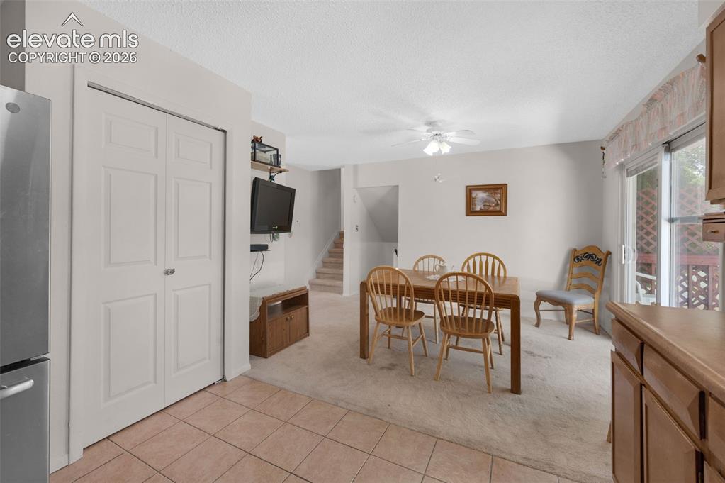 Image 7 of 25: Combined dining and living area featuring a sliding glass door, overhead ce