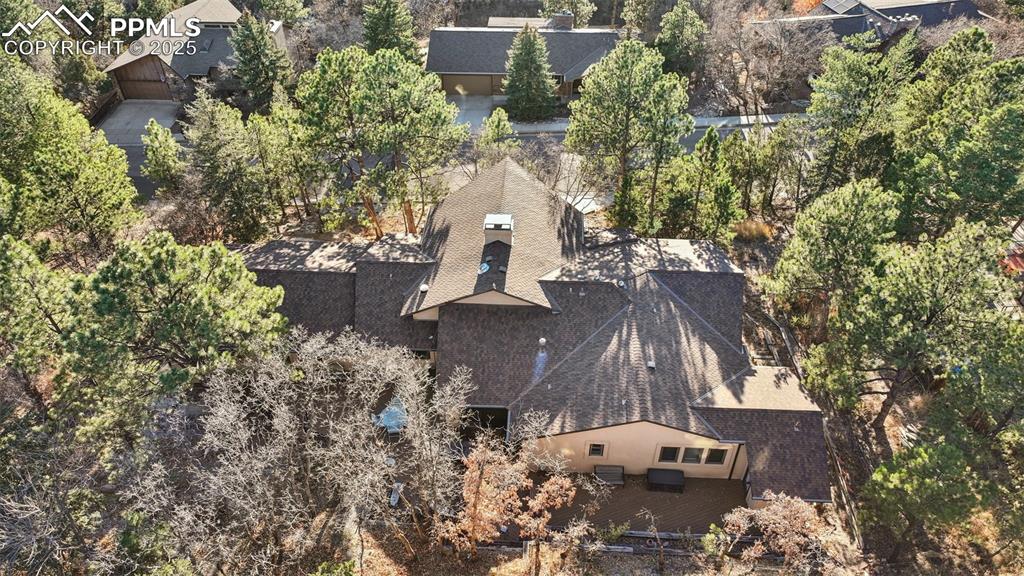 Image 10 of 48: View of subject property with a tree filled landscape