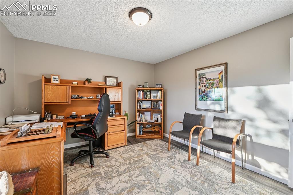 Image 26 of 48: Office featuring a textured ceiling and light wood-type flooring