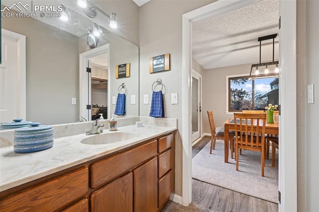 Image 35 of 48: Bathroom featuring vanity, dark wood-style floors, and a textured ceiling