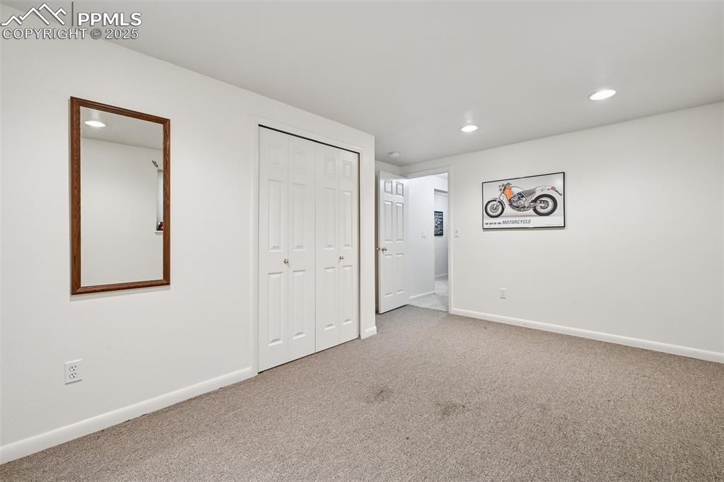 Image 38 of 48: Unfurnished bedroom with carpet floors, recessed lighting, and a closet