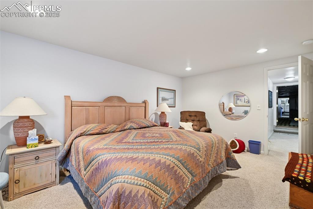 Image 41 of 48: Carpeted bedroom with recessed lighting