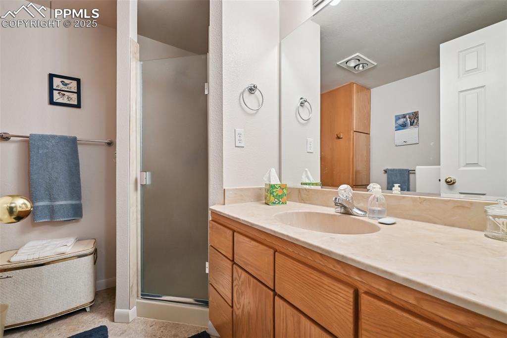Image 42 of 48: Full bath featuring vanity and a stall shower
