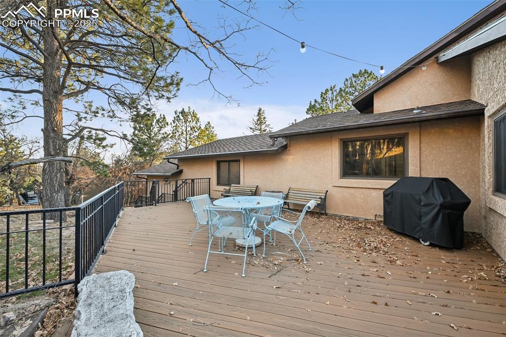 Image 6 of 48: Deck with outdoor dining area and grilling area