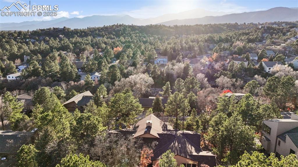 Image 9 of 48: View of property location with mountains and a forest
