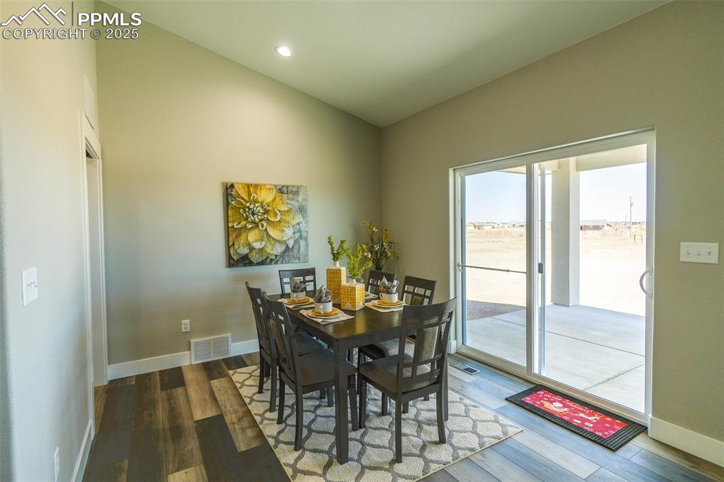 Image 15 of 47: Dining room featuring lofted ceiling and LTV / wood-style floors