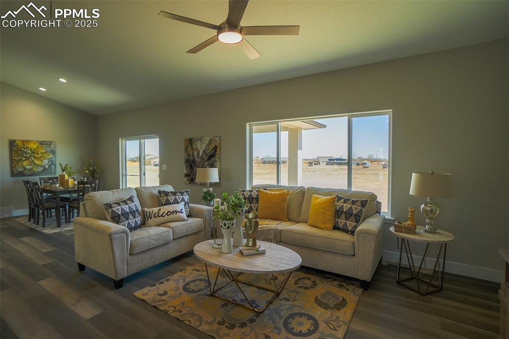 Image 18 of 47: Living room featuring vaulted ceiling, LTV / wood-style floors, ceiling fan