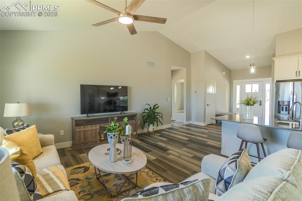 Image 21 of 47: Living room featuring LTV / wood-style flooring, sink, high vaulted ceiling