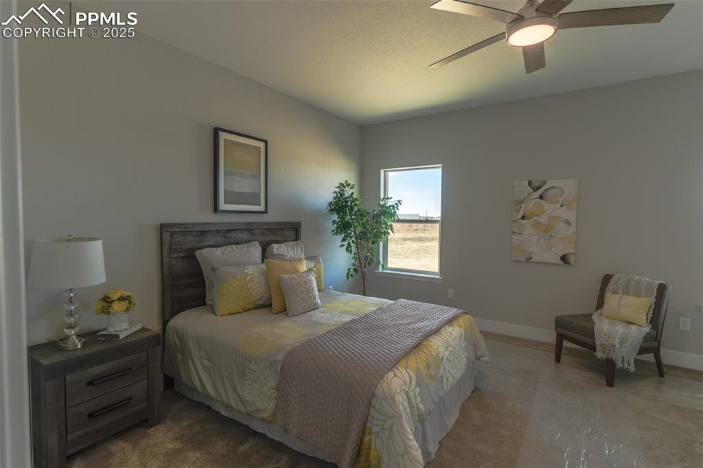Image 22 of 47: Carpeted bedroom with ceiling fan