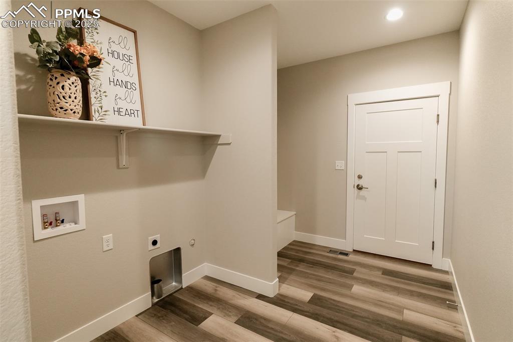 Image 36 of 47: Clothes washing area featuring hookup for an electric dryer, LTV/ wood-styl