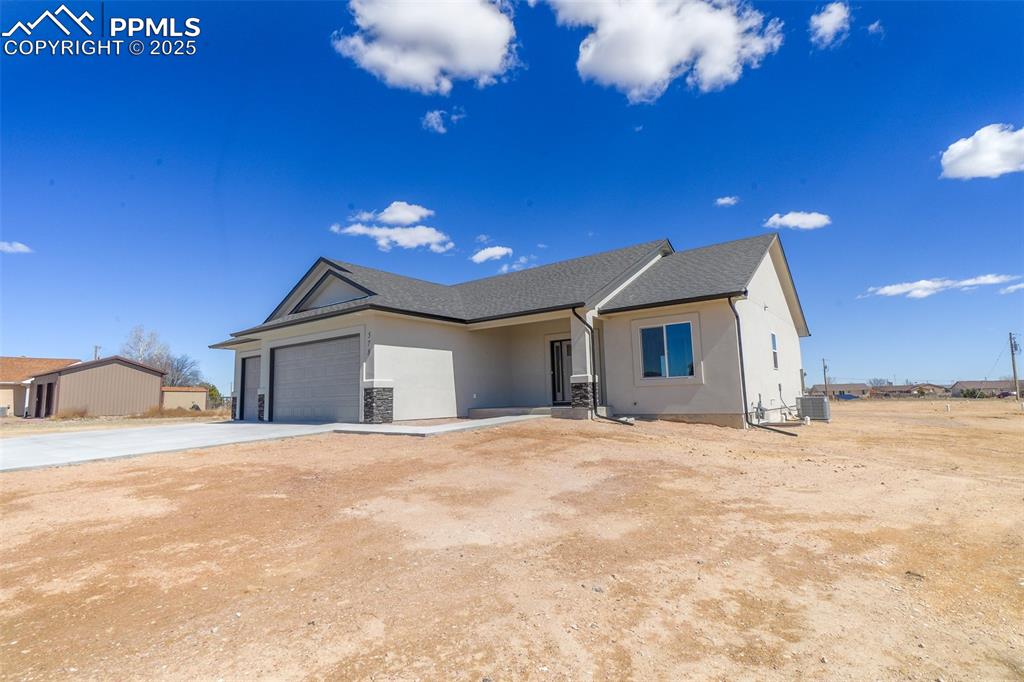 Image 5 of 47: View of front of house with a garage and central air condition unit