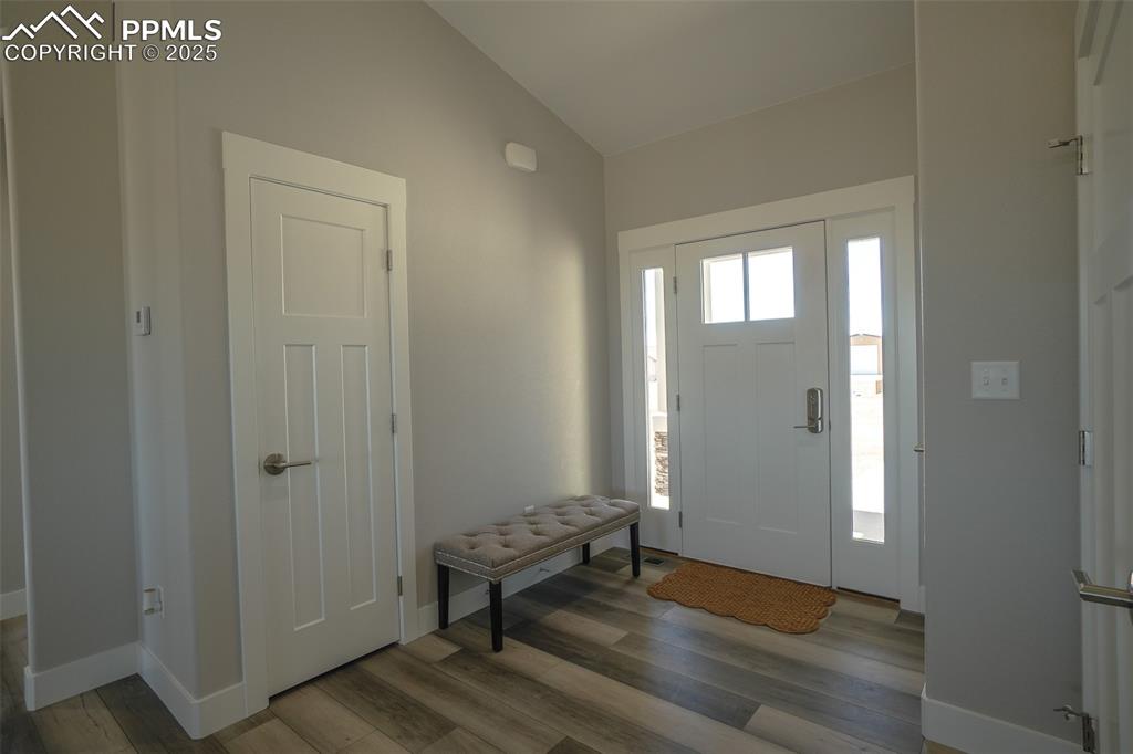 Image 7 of 47: Entrance foyer featuring LTV/ wood-style flooring and lofted ceiling
