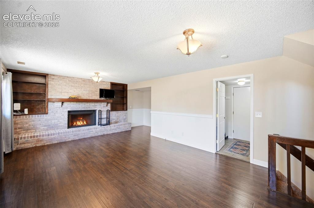 Image 20 of 50: BRICK FIREPLACE WITH BUILT IN SHELVING.