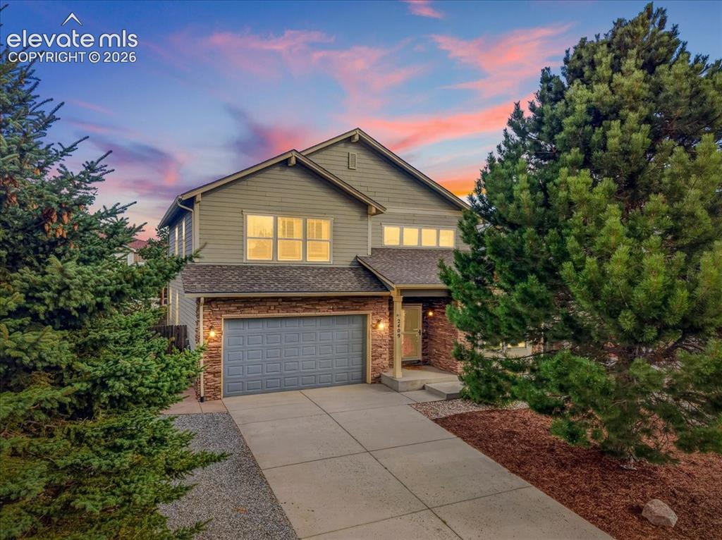 Caption: Two-story residence featuring horizontal siding and stone veneer accents