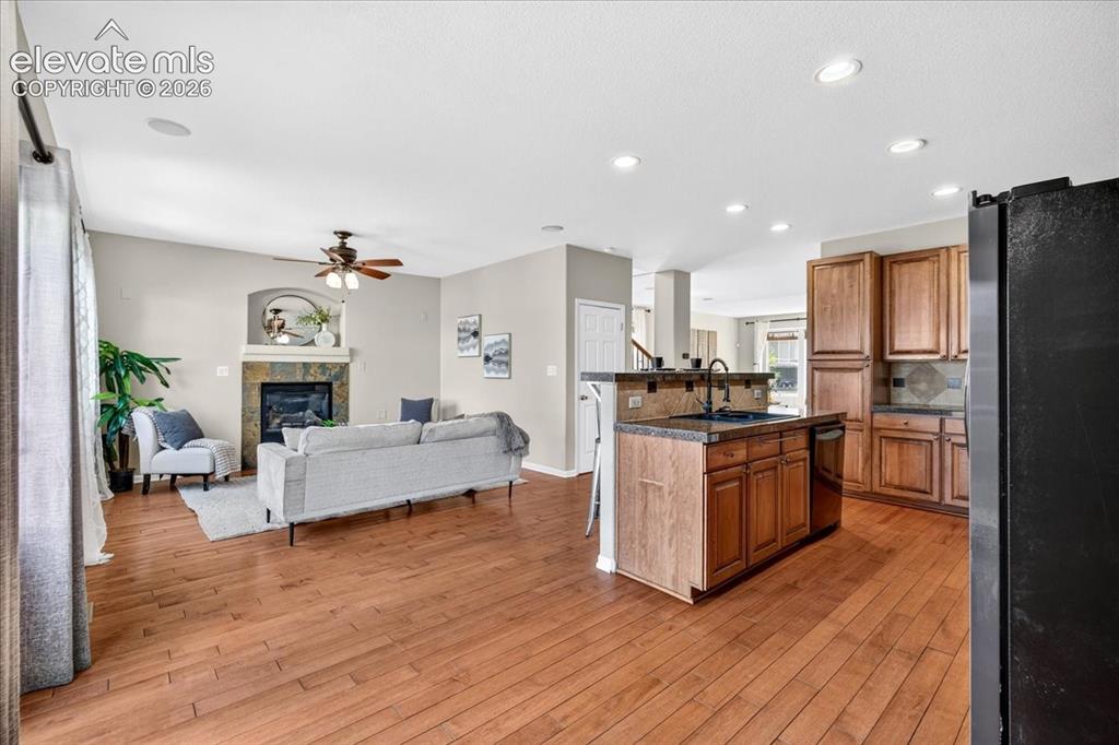 Image 10 of 28: Hardwood-finish flooring, recessed lighting, and a kitchen featuring wood c