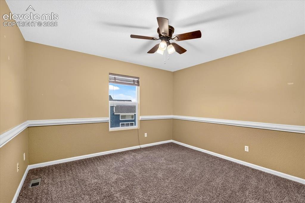 Image 19 of 28: Ceiling fan with integrated lighting, window with blinds, wall with chair r