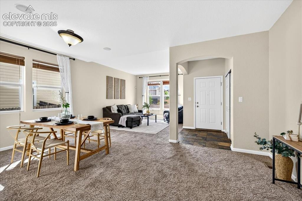 Image 2 of 28: Open-concept living space featuring neutral wall tones, recessed lighting, 