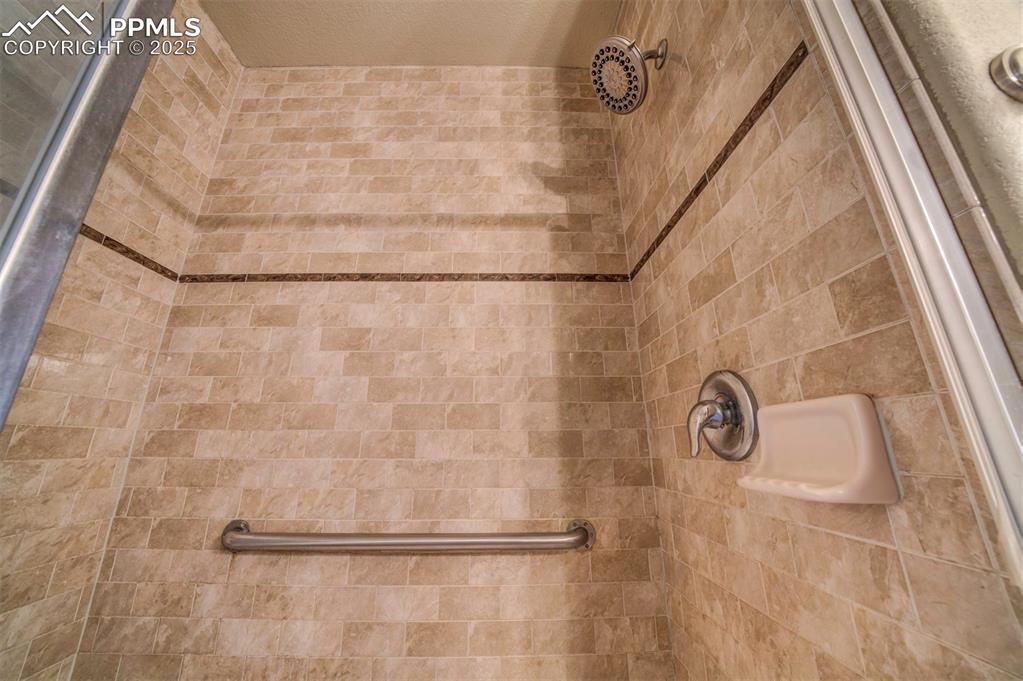 Image 19 of 36: Custom tilework in walk in shower