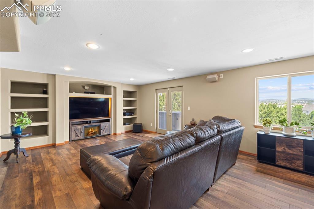 Image 28 of 41: Basement family room with views and walkout.