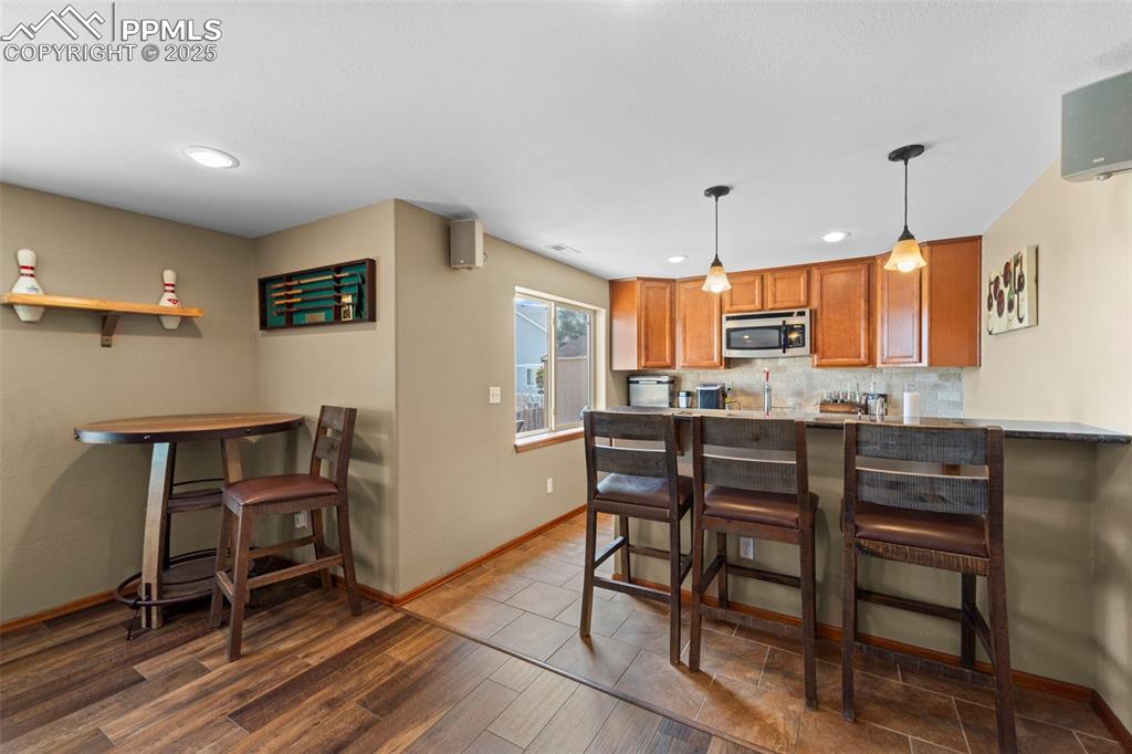 Image 29 of 41: Kitchen with kegorator, wine fridge, dishwasher, sink and microwave.