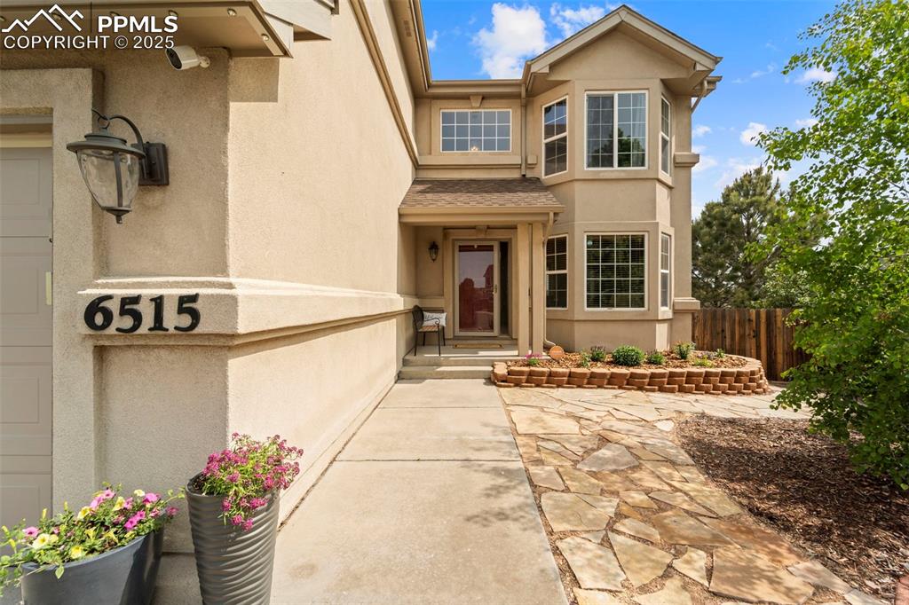 Image 3 of 41: Welcoming entry stucco home