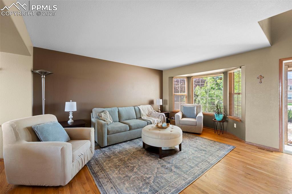 Image 8 of 41: Living room with hardwood floors