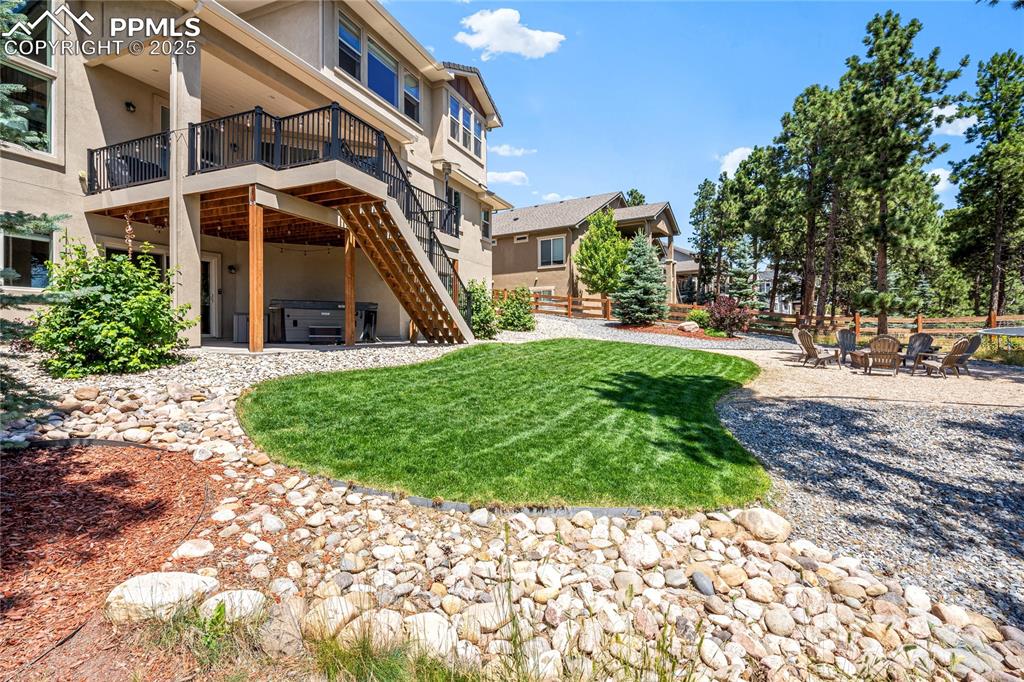 Image 43 of 46: Back of property with a patio, a hot tub, stairs, stucco siding, and a deck