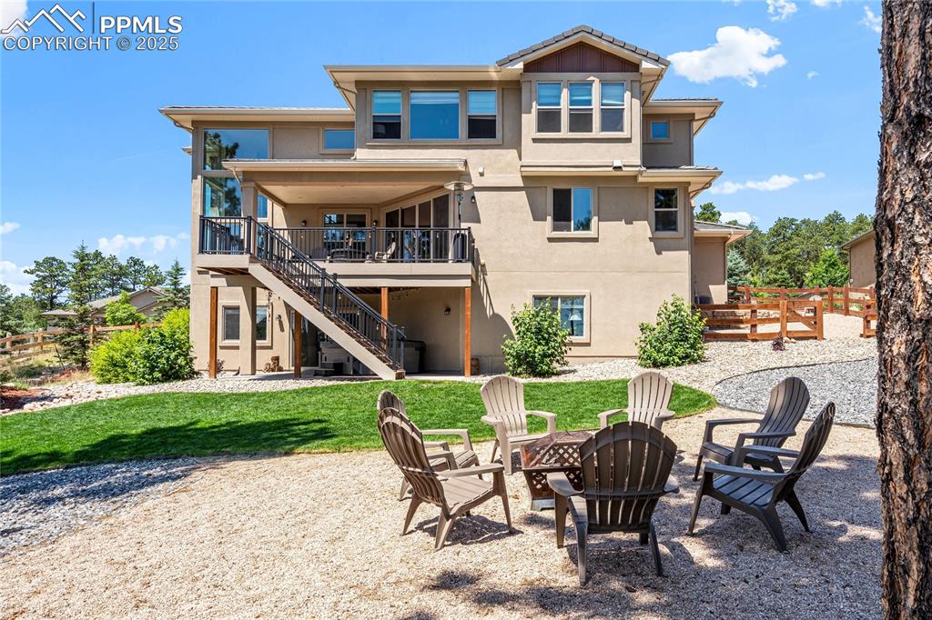 Image 44 of 46: Rear view of property with a patio area, an outdoor fire pit, stairway, stu