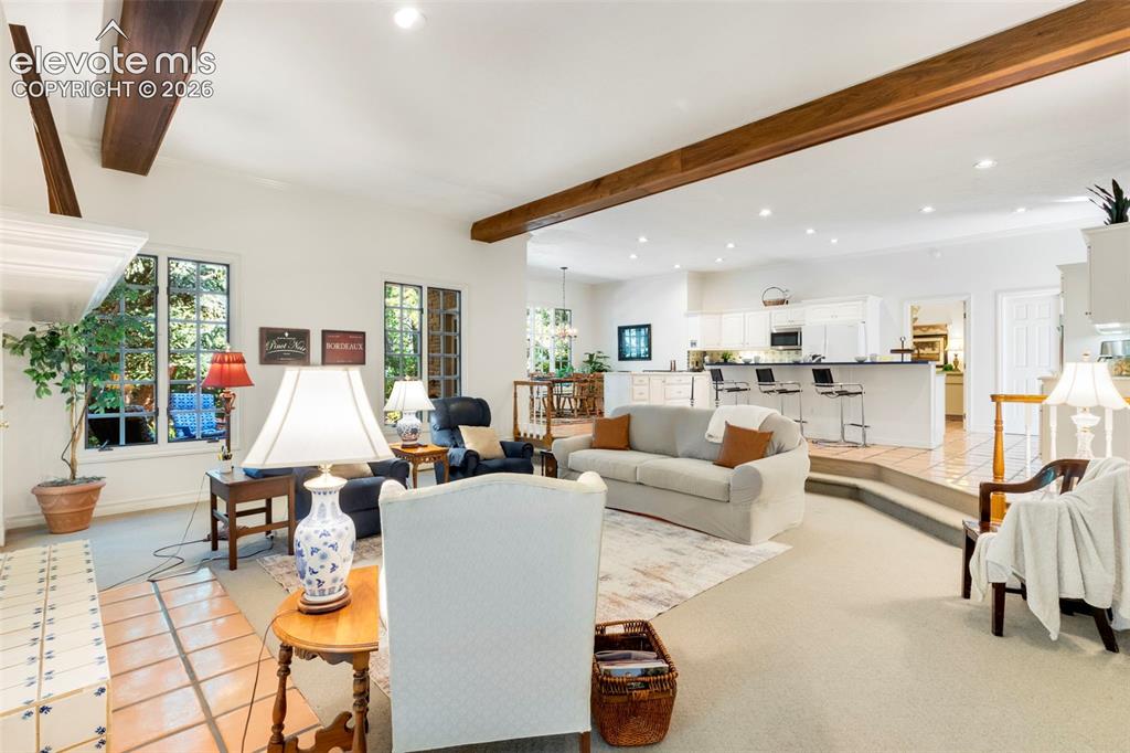 Image 12 of 50: Stepdown family room open to the kitchen and casual dining area with walkou