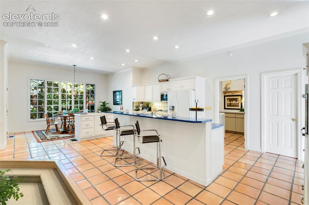 Image 13 of 50: Breakfast bar, casual dining area, walkout