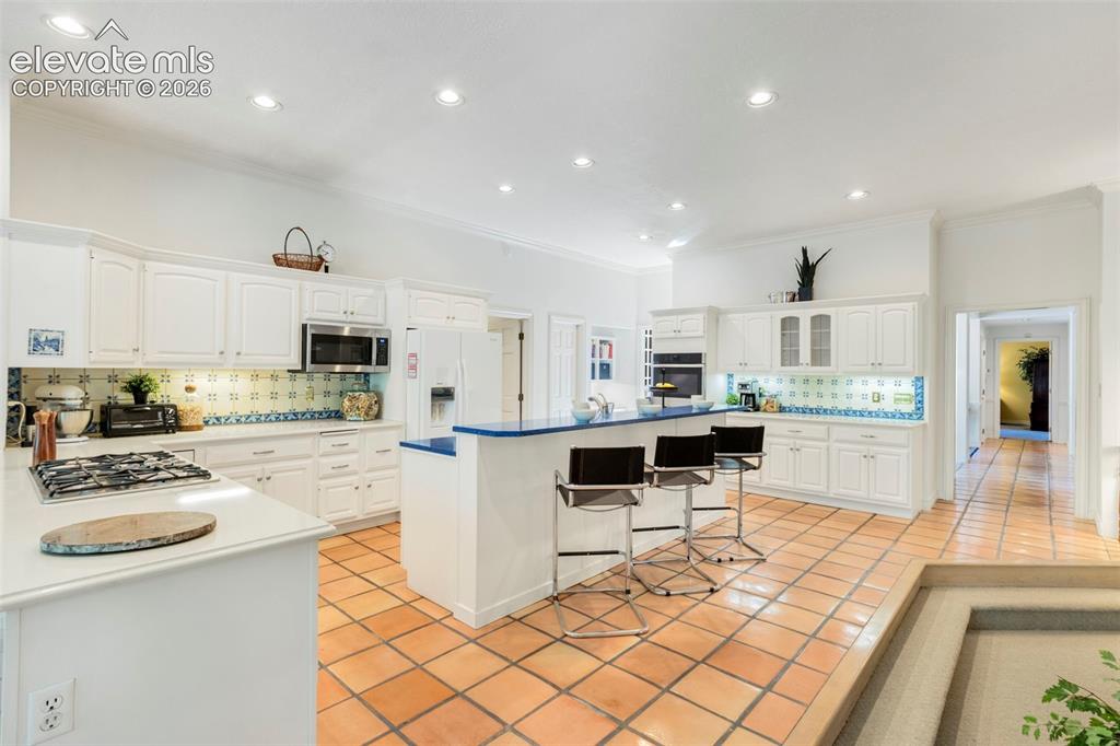 Image 14 of 50: Breakfast bar, lots of cabinetry and counterspace