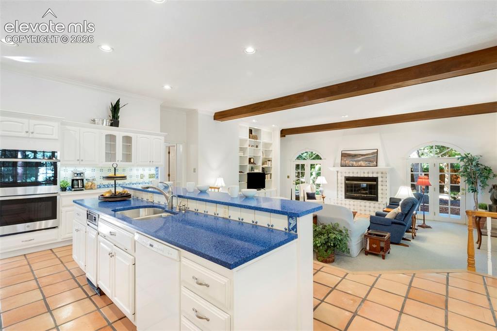 Image 16 of 50: Kitchen and family room with walkout