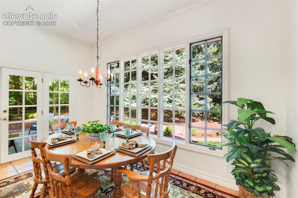 Image 18 of 50: Kitchen casual dining area off kitchen with large windows and walkout