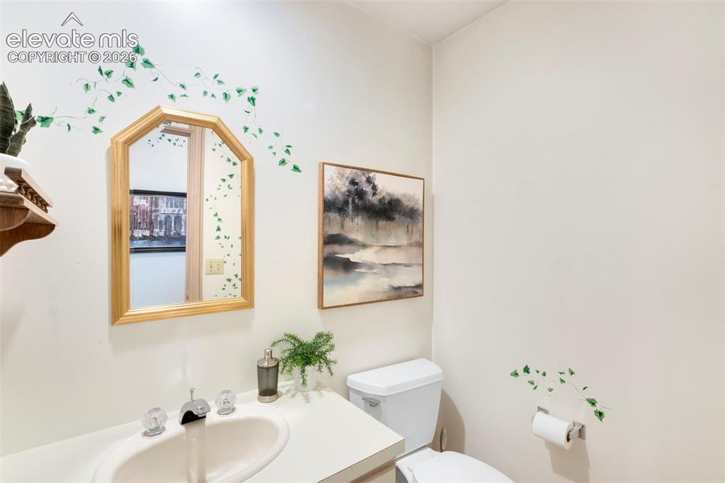 Image 20 of 50: 1/2 bath in laundry area, by garage and workshop