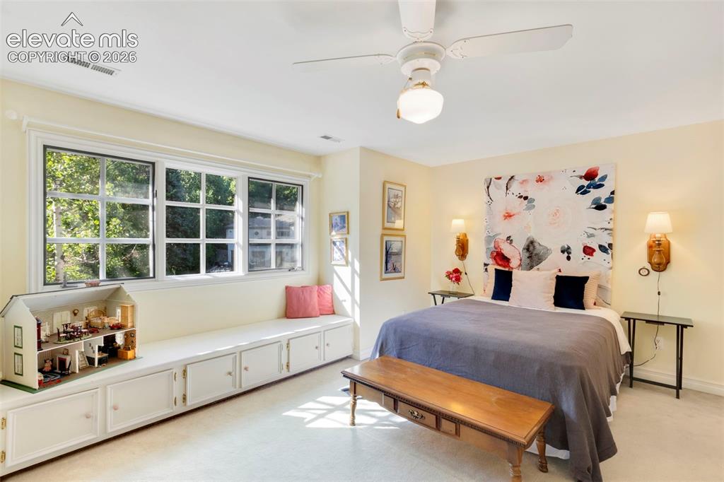 Image 26 of 50: Upstairs bedroom with built-in reading bench