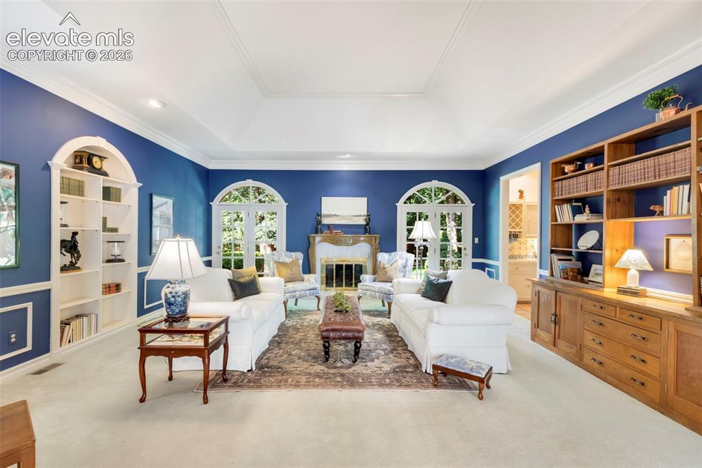 Image 4 of 50: Living room with fireplace, walkouts to yard and open to wet bar