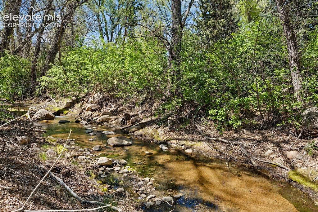 Image 48 of 50: Stream at back of property