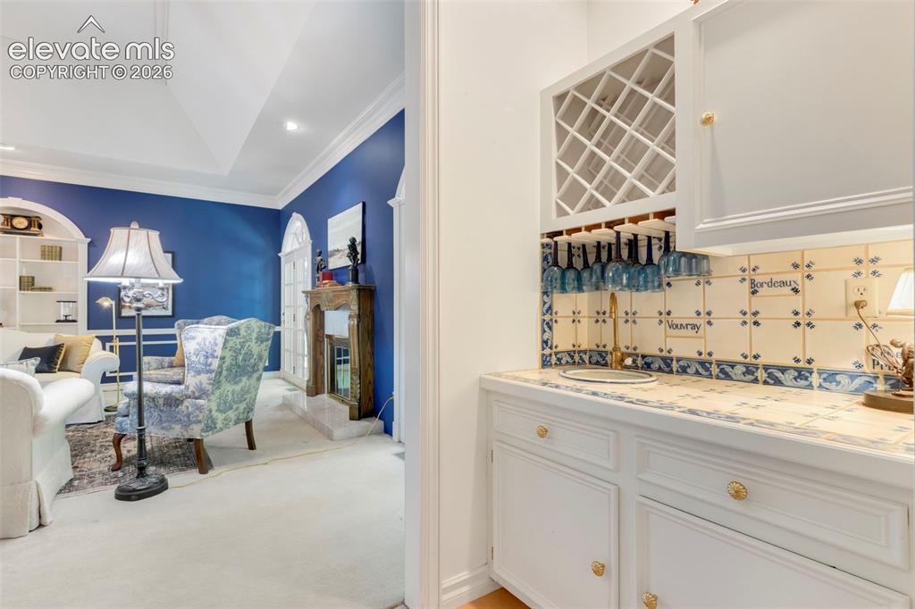 Image 7 of 50: Living Room and Wet bar